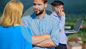 Couple having fun while busy businessman speak on phone. Couple flirting while man busy with mobile conversation. Flirt