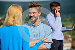 Couple having fun while busy businessman speak on phone. Couple happy flirting while man tense with mobile conversation