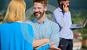 Couple having fun while busy businessman speak on phone. Couple happy flirting while man tense with mobile conversation