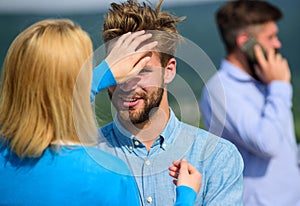 Couple having fun while busy businessman speak on phone. Partners glad to see each other. Couple happy flirting while