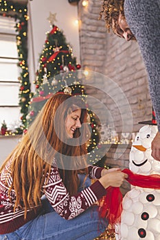 Couple having fun decorating home for Christmas