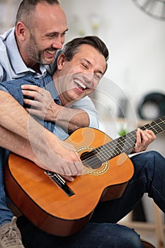 Couple having fun with guitars photo