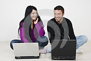 Couple having fun on laptops