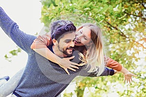 Couple having fun man giving piggyback to woman