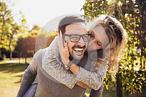 Couple having fun man giving piggyback to woman