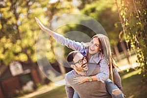 Couple having fun man giving piggyback to woman