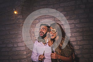 Couple having fun at New Years Eve party midnight countdown