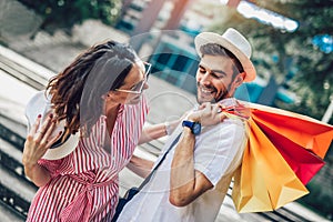 Couple having fun outdoor while doing shopping