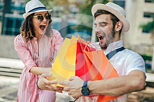 Couple having fun outdoor while doing shopping