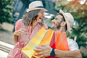 Couple having fun outdoor while doing shopping