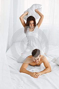 Couple having fun. Pillow Fight.