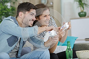 couple having fun playing computer game at home