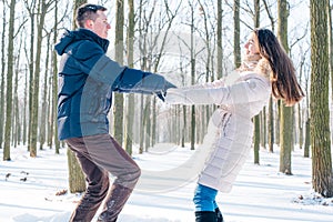 Couple having fun in snowy park