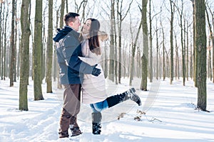 Couple having fun in snowy park