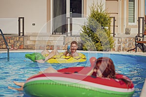 Couple having fun splashing water on each other at the swimming pool