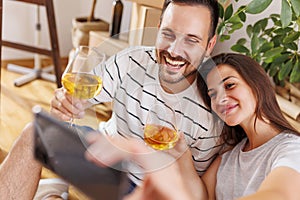 Couple having fun taking selfies in their new apartment