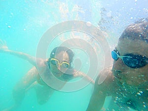 Couple having fun underwater in the sea
