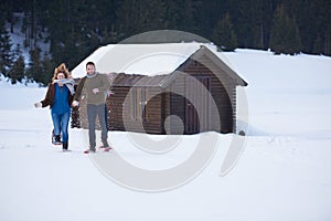 Couple having fun and walking in snow shoes