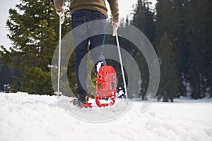 Couple having fun and walking in snow shoes