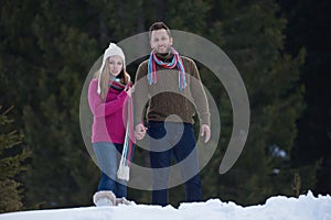 Couple having fun and walking in snow shoes