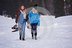 Couple having fun and walking in snow shoes