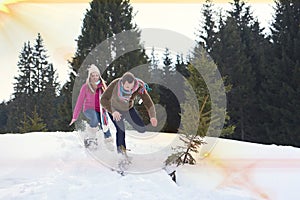 Couple having fun and walking in snow shoes