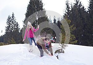 Couple having fun and walking in snow shoes