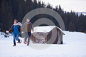 Couple having fun and walking in snow shoes