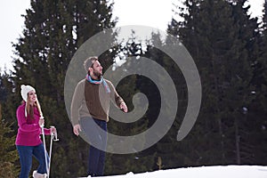 Couple having fun and walking in snow shoes