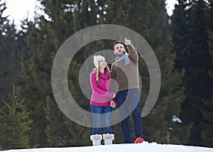 Couple having fun and walking in snow shoes