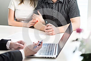 Couple having meeting with banker in bank or salesman in office.