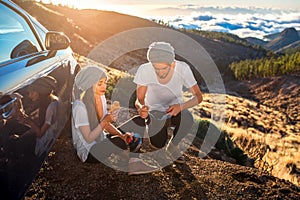 Couple having picnic near the car