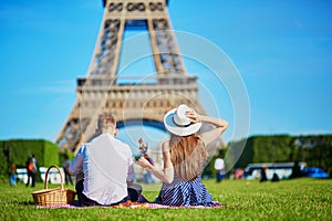 Couple having picnic near the Eiffel tower in Paris