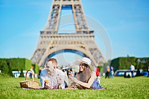 Couple having picnic near the Eiffel tower in Paris, France