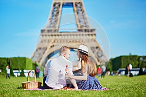 Couple having picnic near the Eiffel tower in Paris, France