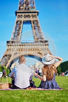 Couple having picnic near the Eiffel tower in Paris, France