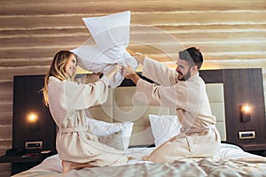 Couple Having Pillow Fight in Hotel Room