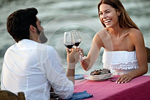 Couple is having a private event dinner on a tropical beach during sunset time