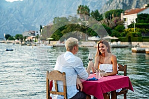 Couple is having a private event dinner on a tropical beach during sunset time