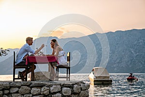 Couple is having a private event dinner on a tropical beach during sunset time