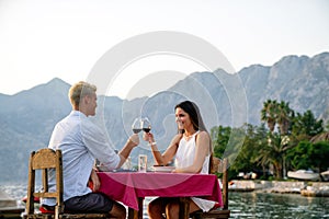 Couple is having a private event dinner on a tropical beach during sunset time