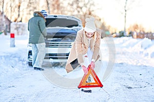 Couple having problem with the car during winter trip