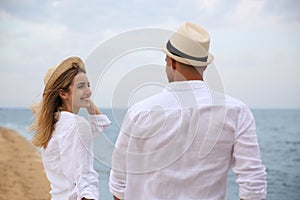 Couple having romantic walk on beach