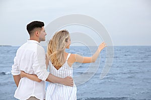Couple having romantic walk on beach