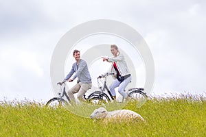 Couple having sea coast bicycle tour at levee