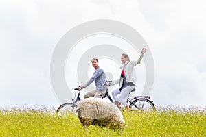 Couple having sea coast bicycle tour at levee