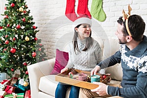 Couple Having Snacks At Home During Christmas