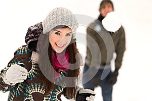 Couple having snowball fight