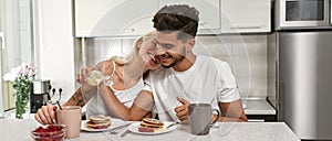 Couple having tasty breakfast at home kitchen