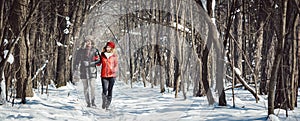 Couple having a winter walk on a chilly cold day in the woods